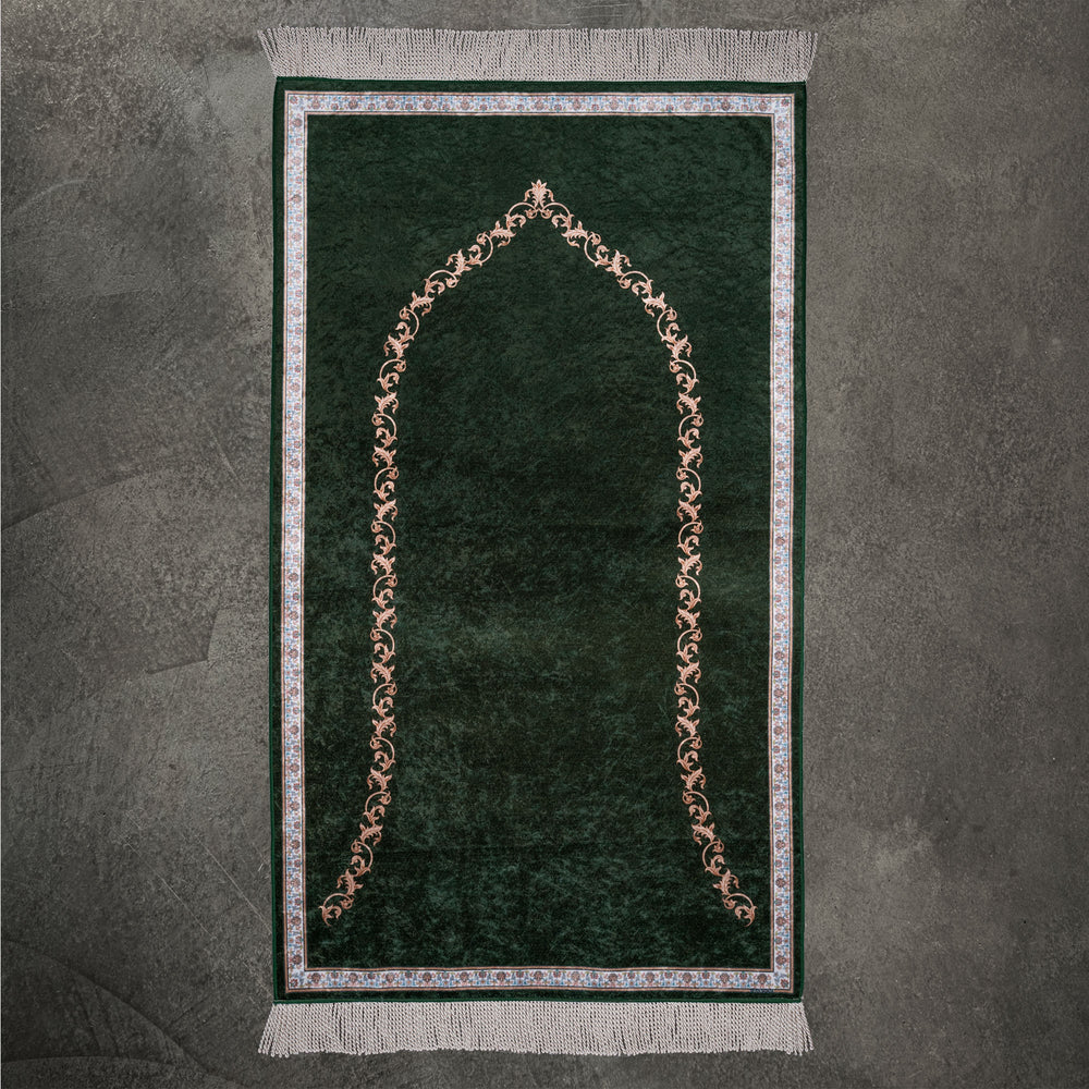 Elegant prayer mat in green with a fine floral mihrab arch outline, full view